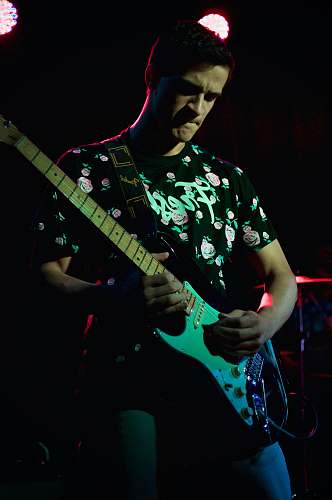 electric guitar man in black and white floral crew neck t-shirt playing electric guitar leisure activities